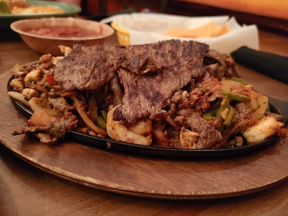 Beef Chorizo Shrimp Chicken & Skirt Steak Sizzling Fajita Platter